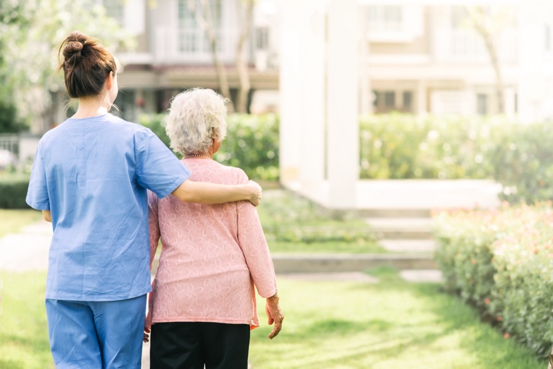 A caregiver offers friendly support and companionship to a client at her home.